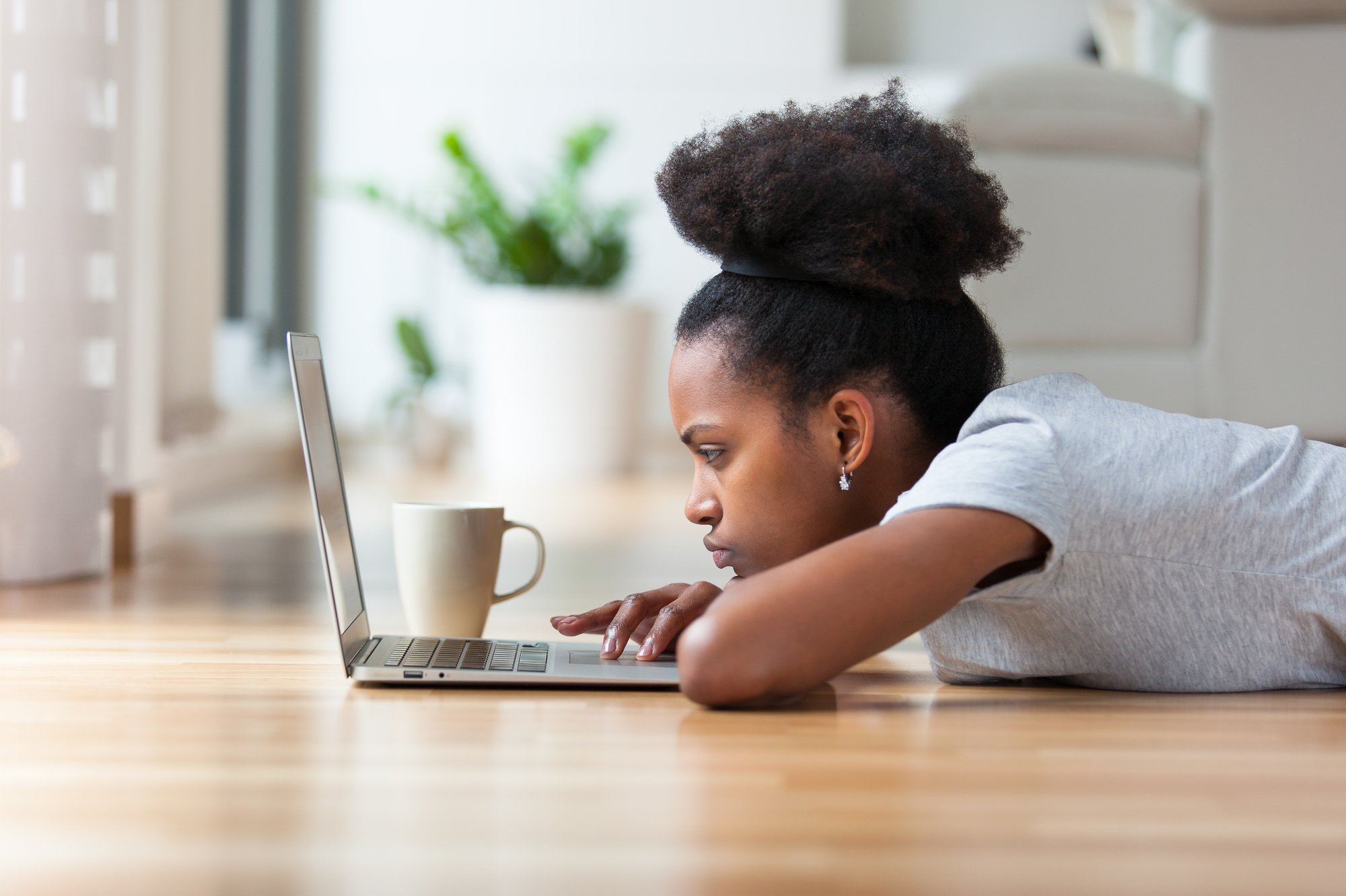 African American woman using a laptop in her living room