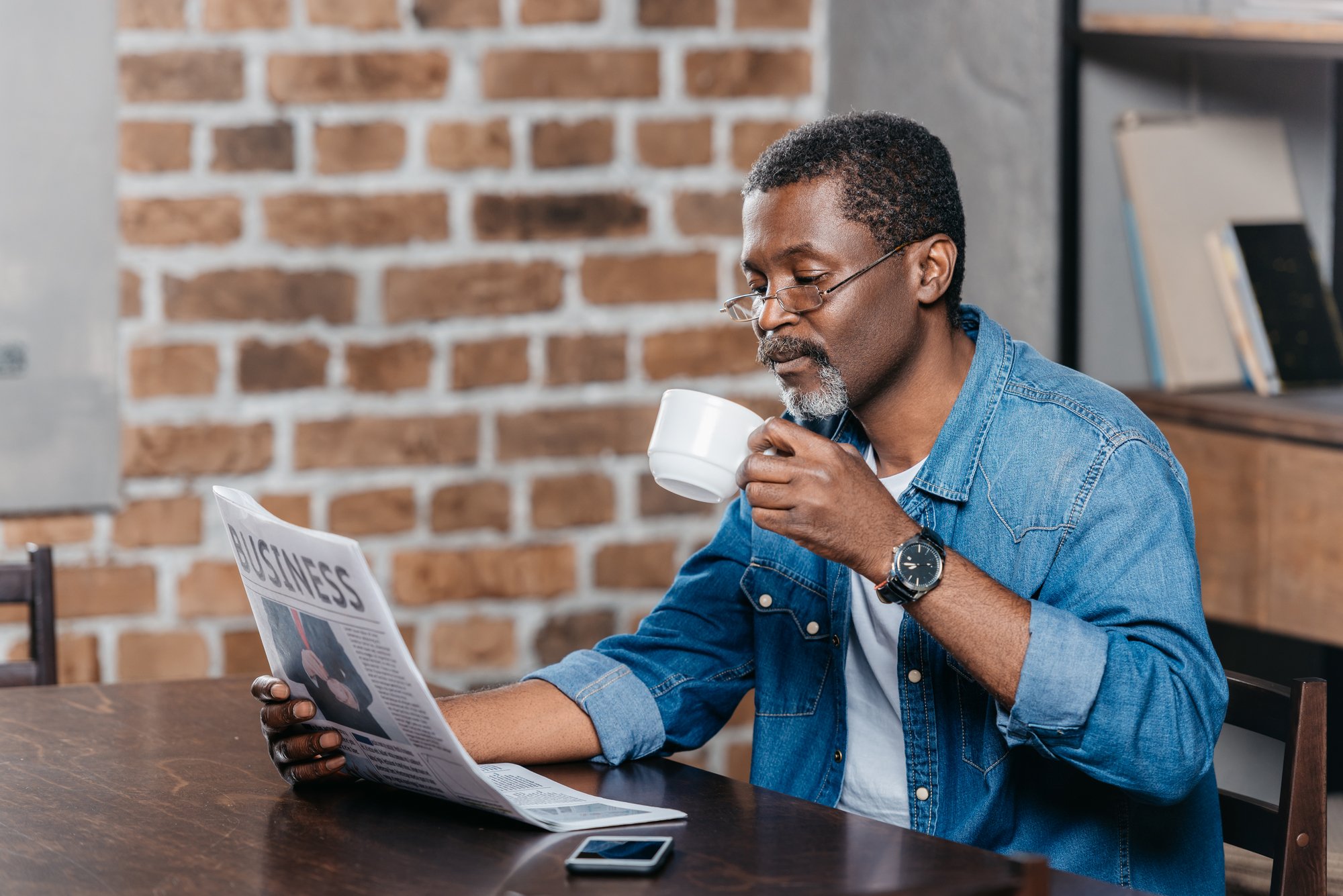 African american man reading newspaper