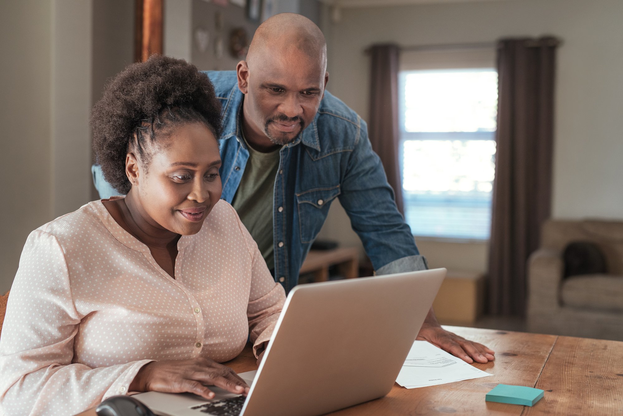 Couple paying bills with laptop