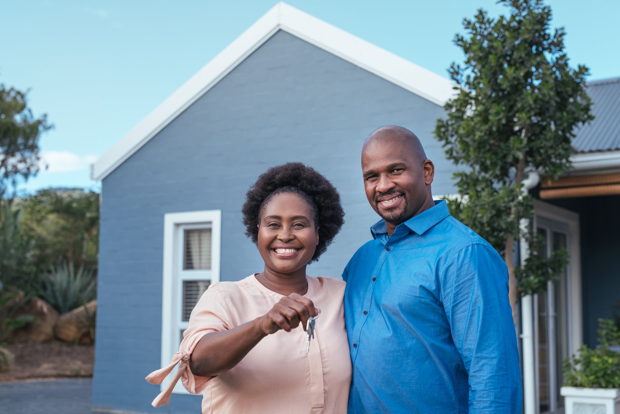 Couple standing with keys to new home