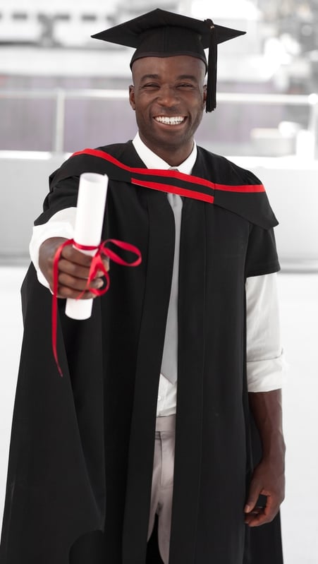 Man smilling at university graduation celebration