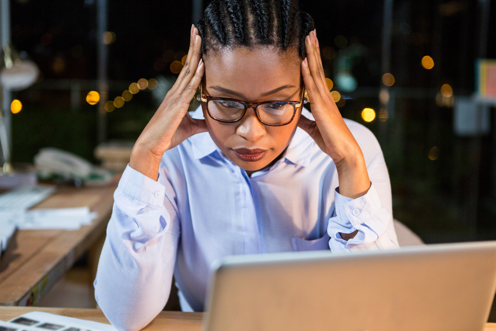 Stressed businesswoman sitting at her desk in the office